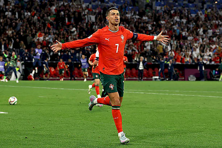 Cristiano Ronaldo, cầu thủ ghi bàn nhiều nhất mọi thời đại, đang ăn mừng bàn thắng trên sân cỏ