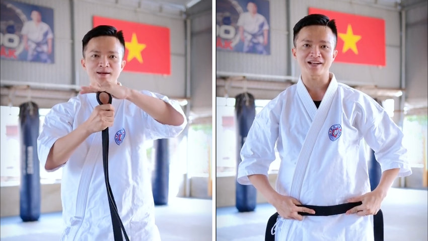 Võ sinh gấp đôi đai Karate để xác định điểm giữa, chuẩn bị cho cách thắt đai võ Karate truyền thống.