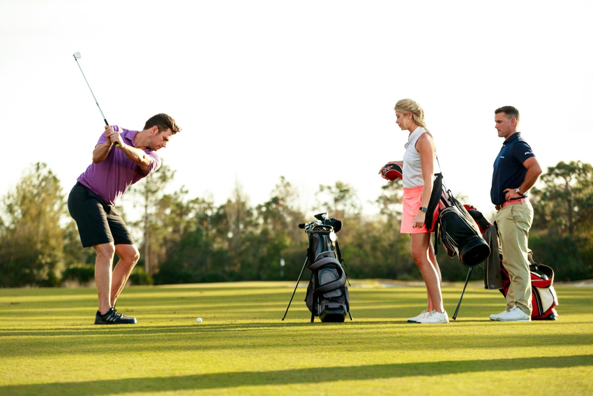 Nhóm golfer tập trung thảo luận luật chơi golf trên sân cỏ